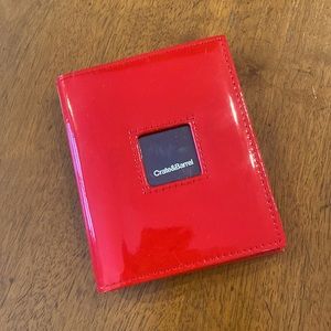 Crate&Barrel red patent mini photo album w/display cover. Holds 24-2.5x3.5” pics